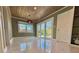 Elegant dining area featuring wood paneling, a modern light fixture, and marble floors at 2785 Sydelle St, Sarasota, FL 34237