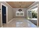 Elegant dining area featuring wood paneling, a modern light fixture, and marble floors at 2785 Sydelle St, Sarasota, FL 34237