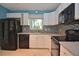 Kitchen featuring stainless steel appliances, white cabinets, and stylish tiled backsplash, well-lit by a window at 2785 Sydelle St, Sarasota, FL 34237