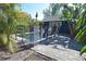 Backyard view of the private pool area with brick pavers surrounded by lush tropical landscaping at 2785 Sydelle St, Sarasota, FL 34237