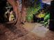 Evening view of the brick paver patio surrounded by trees and tropical foliage at 2785 Sydelle St, Sarasota, FL 34237