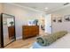 Bright bedroom featuring wood floors, dresser with decorations, and full-length mirror at 2823 Marshall Dr, Sarasota, FL 34239