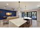 Open floor plan showcasing the kitchen island flowing into the modern living room with a striking blue accent wall at 2823 Marshall Dr, Sarasota, FL 34239