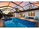 Covered patio, showcasing a view of the pool and interior at 2823 Marshall Dr, Sarasota, FL 34239