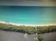 Stunning aerial view of a private beach with turquoise water and lush, tropical vegetation at 3060 Arrowhead Rd, Venice, FL 34293