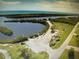 Aerial view showcases a boat launch and parking area near the water at 3060 Arrowhead Rd, Venice, FL 34293