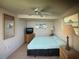 Cozy bedroom featuring a ceiling fan, neutral decor, and ample natural light from the window at 3060 Arrowhead Rd, Venice, FL 34293