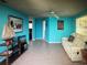 Vibrant living room with turquoise walls, comfortable seating, and stylish décor, creating a welcoming atmosphere at 3060 Arrowhead Rd, Venice, FL 34293