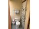 Modest bathroom featuring a toilet, shower with floral curtain, and towel rack at 3252 Patton St, Sarasota, FL 34235