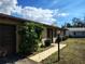 Street view of a single-story home with a driveway, brown garage door, and well-kept landscaping at 3252 Patton St, Sarasota, FL 34235