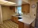 Bright kitchen featuring laminate counters, plenty of cabinet space, and a stainless steel sink at 3252 Patton St, Sarasota, FL 34235