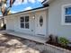 Close up of the home's entrance with a decorative glass door and fresh landscaping at 3325 Woodmont Dr, Sarasota, FL 34232