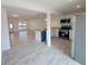 Open kitchen with white cabinets, stainless steel appliances and an open view of the living area at 3325 Woodmont Dr, Sarasota, FL 34232