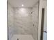 Updated tiled shower featuring a shower niche and glass surround at 3325 Woodmont Dr, Sarasota, FL 34232