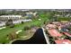 Aerial view of community featuring lush landscape, golf course, and ponds at 3500 El Conquistador Pkwy # 336, Bradenton, FL 34210