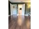 Bedroom entryway showcases hardwood floors and double doors leading to updated bathroom at 3500 El Conquistador Pkwy # 336, Bradenton, FL 34210