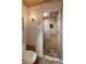 Elegant bathroom with tile walls and floors and a glass door shower at 3951 Palau Dr, Sarasota, FL 34241