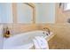 Luxurious bathroom with a soaking tub and elegant fixtures at 3951 Palau Dr, Sarasota, FL 34241