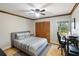 Comfortable bedroom with a ceiling fan, closet, and natural light from the window at 3951 Palau Dr, Sarasota, FL 34241