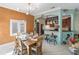 A dining room shows a rustic table setting, bar stool seating, and a decorative light fixture at 3951 Palau Dr, Sarasota, FL 34241