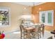 Sunlit dining room with a unique hydroponic garden and view to the landscaped backyard at 3951 Palau Dr, Sarasota, FL 34241