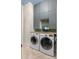 Functional laundry room with washer, dryer, and storage cabinets at 3951 Palau Dr, Sarasota, FL 34241