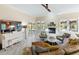 Bright living room with a fireplace, stylish decor, a piano, and sliding doors to the patio at 3951 Palau Dr, Sarasota, FL 34241