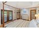 Bright main bedroom featuring a four-poster bed, french doors, and stylish furnishings at 3951 Palau Dr, Sarasota, FL 34241