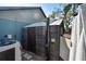 Inviting outdoor shower with dark wood, silver fixtures, and a privacy curtain at 3951 Palau Dr, Sarasota, FL 34241