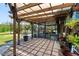 Covered patio with a view of the pool and lush garden, creating a serene outdoor living space at 3951 Palau Dr, Sarasota, FL 34241