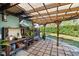 Outdoor potting area with stone tiles, wooden beams, and lush greenery at 3951 Palau Dr, Sarasota, FL 34241