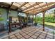 Relaxing outdoor patio with a pergola, stone pavers, potting table and lots of sunshine at 3951 Palau Dr, Sarasota, FL 34241