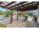 Large patio with a pergola, ideal for outdoor entertaining and relaxing by the pool at 3951 Palau Dr, Sarasota, FL 34241