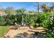 Backyard garden with a fish pond, small waterfall, tropical plants and stone pavers at 3951 Palau Dr, Sarasota, FL 34241