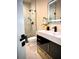 Modern bathroom with a large vanity, illuminated mirror, and marble shower at 4396 Everglades Ter, North Port, FL 34286