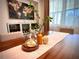 Close up of the dining room table, featuring a plant and decorative jars at 4396 Everglades Ter, North Port, FL 34286