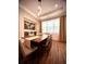 Elegant dining room featuring a wood table, unique lighting, and a stylish map art piece at 4396 Everglades Ter, North Port, FL 34286