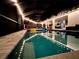 Resort-style pool featuring a volleyball net, illuminated by string lights creating a fun and inviting ambiance at 4396 Everglades Ter, North Port, FL 34286