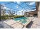 Screened-in pool with attached spa overlooking an outdoor living area and landscaped yard at 4744 Benito Ct, Bradenton, FL 34211