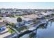 Aerial view of a waterfront home with a screened-in pool, boat dock, and canal access at 5012 Bimini Dr, Bradenton, FL 34210