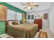 Inviting bedroom adorned with vintage decor, floral wallpaper and natural light at 5012 Bimini Dr, Bradenton, FL 34210