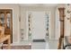 A charming foyer showcasing original tile flooring, a built-in china cabinet, and decorative stained-glass sidelights at 5012 Bimini Dr, Bradenton, FL 34210