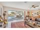 Cozy living room with large sliding glass doors leading to a screened-in lanai and pool area at 5012 Bimini Dr, Bradenton, FL 34210