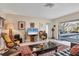 Cozy living room with large sliding glass doors leading to a screened-in lanai and pool area at 5012 Bimini Dr, Bradenton, FL 34210