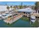 Waterfront view of a lively marina with boats, a restaurant, and docks at 5012 Bimini Dr, Bradenton, FL 34210