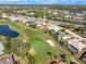 Stunning aerial view of home on golf course with lush landscaping, pond, and neighborhood at 5080 Kilty E Ct, Bradenton, FL 34203