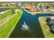 Aerial view of the community golf course, lakeside restaurant, swimming pool and fountain at 5080 Kilty E Ct, Bradenton, FL 34203