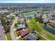 High-angle shot of a neighborhood featuring a golf course, pond, and meticulously kept lawns at 5080 Kilty E Ct, Bradenton, FL 34203