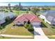 Aerial view of a home with a red tile roof, lush landscaping, and a well-manicured lawn at 5080 Kilty E Ct, Bradenton, FL 34203