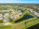 Aerial view of a well-kept residential community with golf courses, ponds, and lush landscaping on a sunny day at 5080 Kilty E Ct, Bradenton, FL 34203